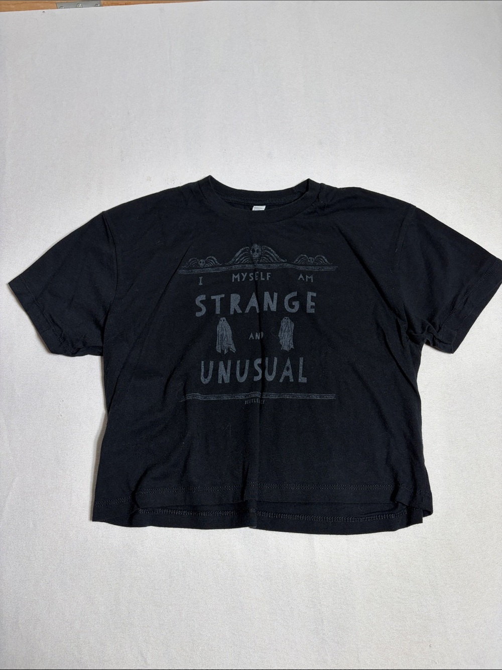 H&M Black Graphic Tee with 'Strange and Unusual' Print
